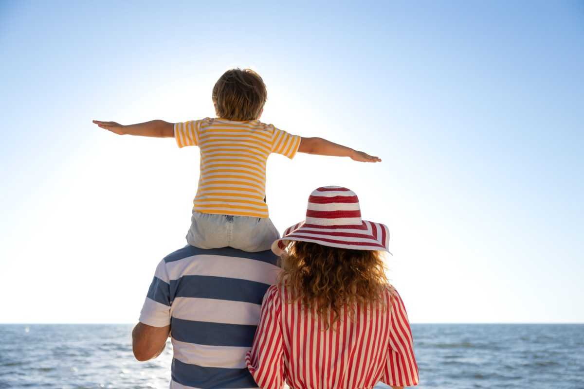 Happy,Family,Having,Fun,On,The,Beach.,Mother,,Father,And